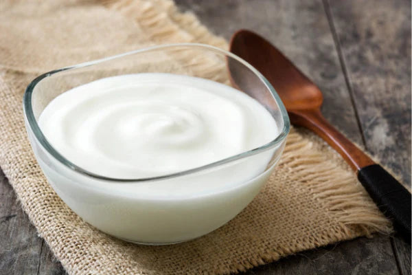 Curd in bowl and spoon kept aside | benefits of curd for hair