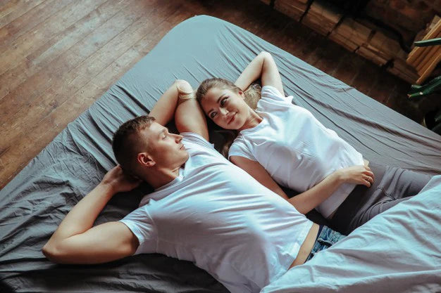 Couple lying on bed | Gokshura benefits  for male