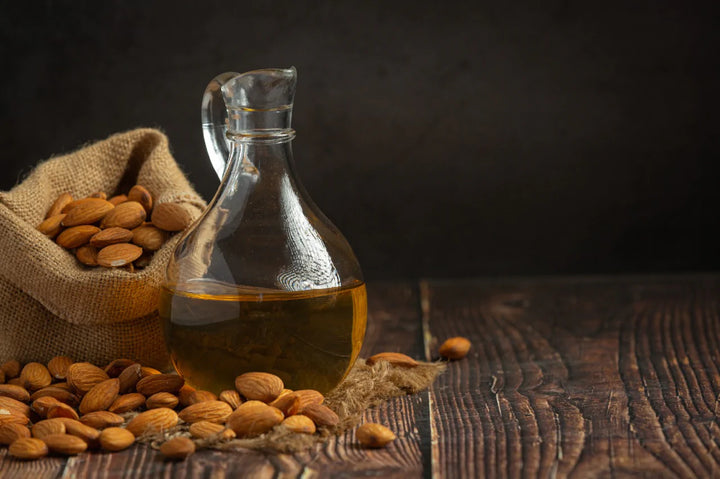 Almonds kept in sack and almond oil in glass jar | almond oil benefits for face