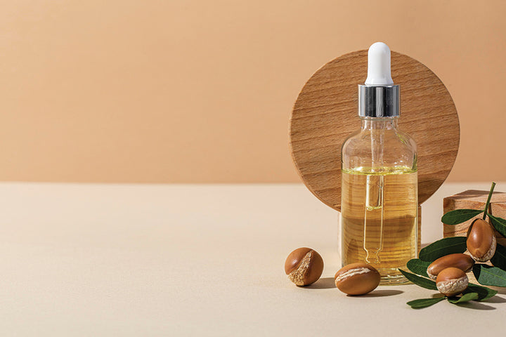 Bottle of jojoba oil with seeds | Jojoba oil benefits for hair