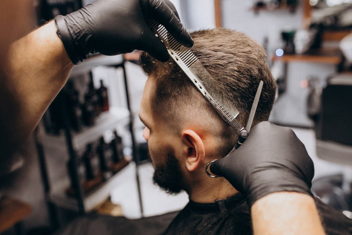 man getting a hair cut | Does cutting hair short help hair loss | short hair and hair loss