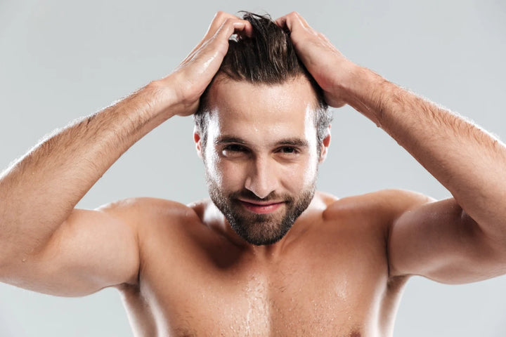 A happy man keeping hands on head | how to increase hair growth for men