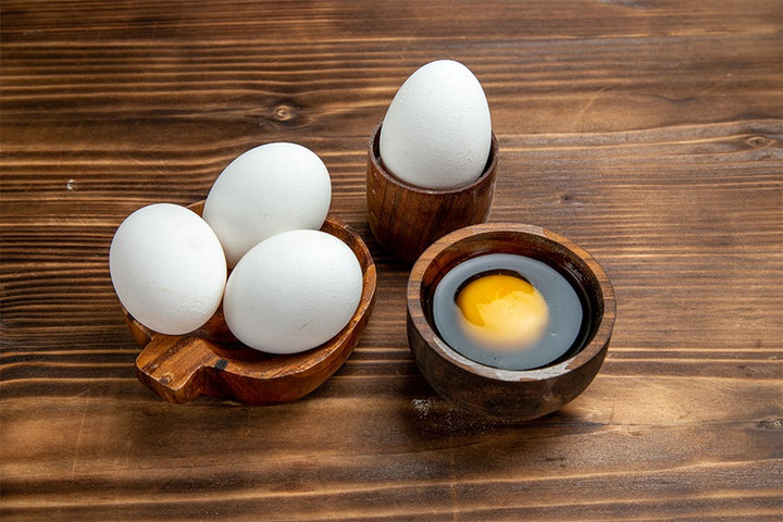 Four eggs and egg yolk kept in bowl | Egg white for hair