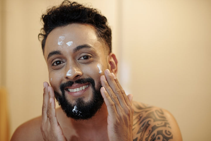a man applying cleanser on his face