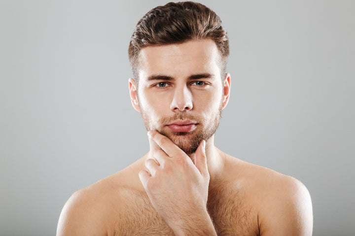 a man with clear skin holding his chin