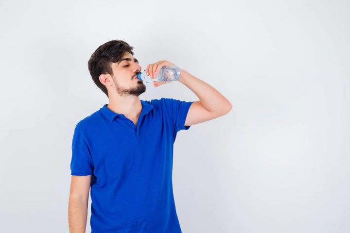 Man drinking water in a bottle | Benefits of drinking water for skin